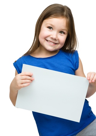 Little girl is holding blank banner, isolated over whiteの写真素材