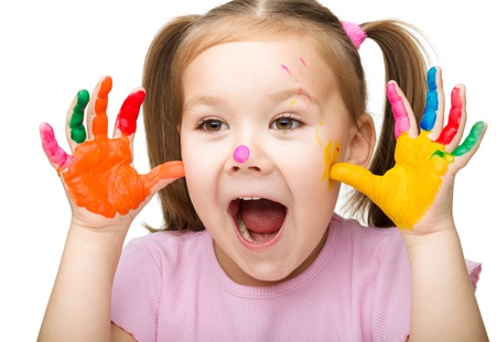 Portrait of a cute cheerful girl showing her hands painted in bright colors, isolated over whiteの写真素材
