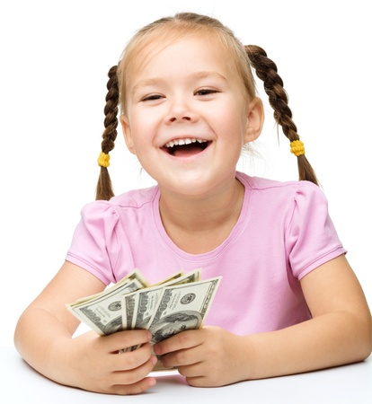 Cute little girl with dollars, isolated over whiteの写真素材