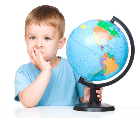 Little boy with a globe, isolated over whiteの写真素材