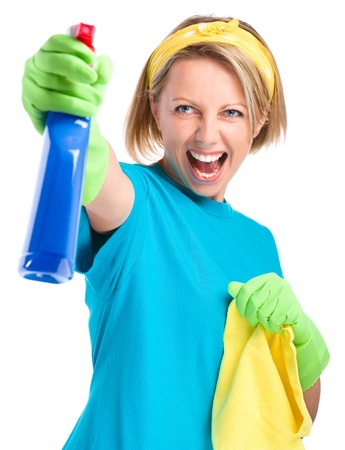 Young woman as a cleaning maid fiercely spraying liquid from blue sprayer, isolated over whiteの写真素材