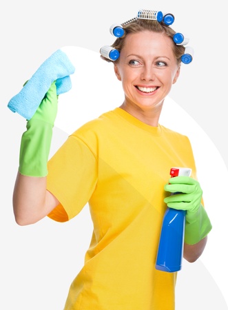 Young woman is cleaning glass using rag, isolated over whiteの写真素材