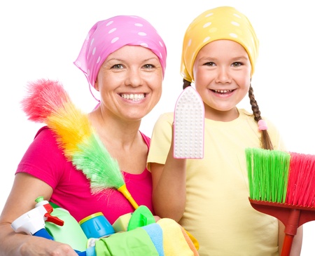 Happy mother and her daughter are dressed for cleaning, isolated over whiteの写真素材