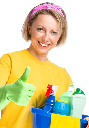 Young woman as a cleaning maid holding bucket full of liquids and showing thumb up gesture, isolated over whiteの写真素材