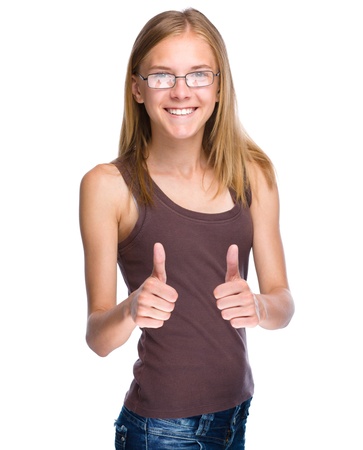 Young woman dressed in blue is showing thumb up gesture using both hands, isolated over whiteの写真素材