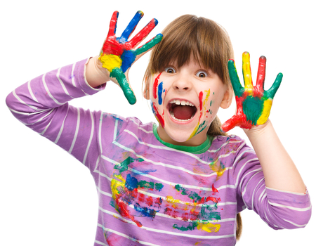 Portrait of a cute cheerful girl showing her hands painted in bright colors, isolated over whiteの写真素材