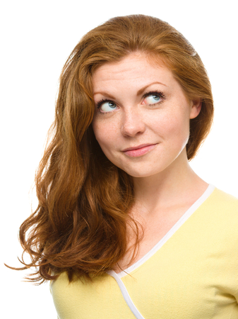 Young woman is looking up and smile, isolated over whiteの写真素材