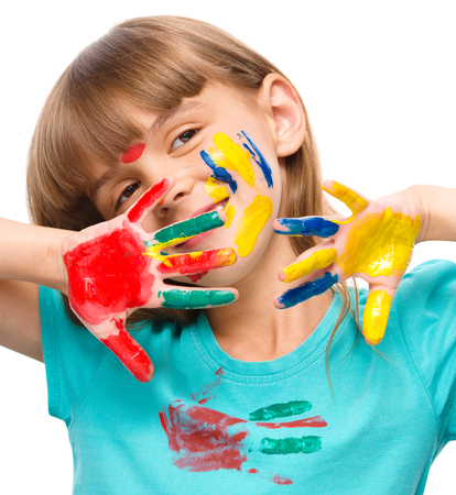 Portrait of a cute cheerful girl showing her hands painted in bright colors, isolated over whiteの写真素材