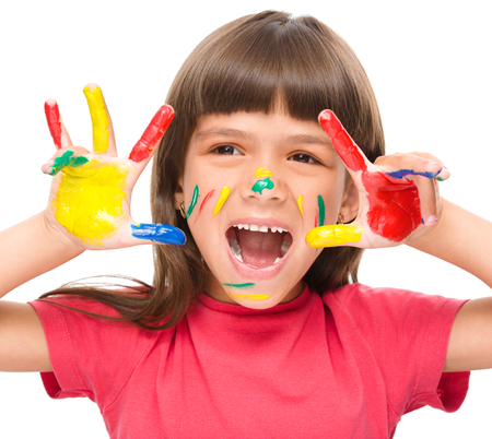 Portrait of a cute girl showing her hands painted in bright colors, isolated over whiteの写真素材