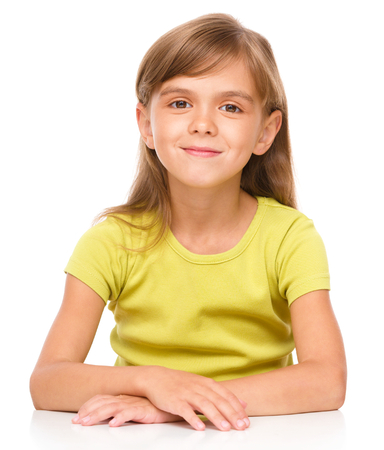 Portrait of a happy little girl laughing, isolated over whiteの写真素材