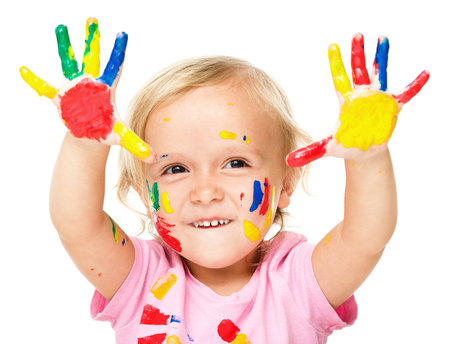 Portrait of a cute little girl showing her hands painted in bright colors, isolated over whiteの写真素材