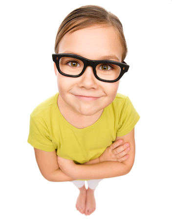Little girl wearing glasses, bad eyesight concept, fisheye portrait, isolated over whiteの写真素材