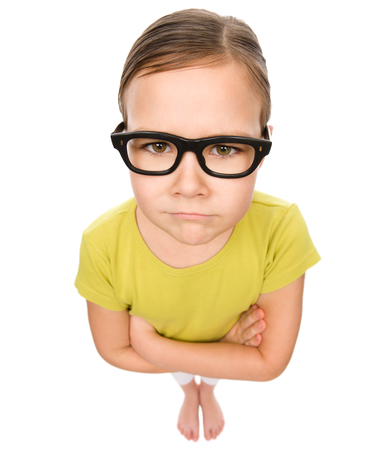 Little girl wearing glasses, bad eyesight concept, fisheye portrait, isolated over whiteの写真素材