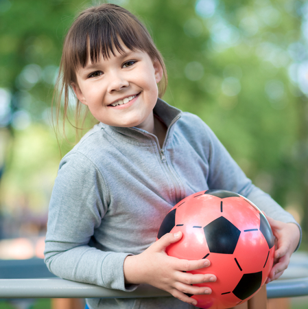 Cute little girl is playing in playground, outdoor shootの写真素材