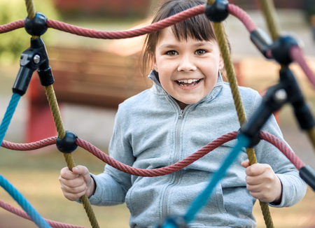 Cute little girl is playing in playground, outdoor shootの写真素材