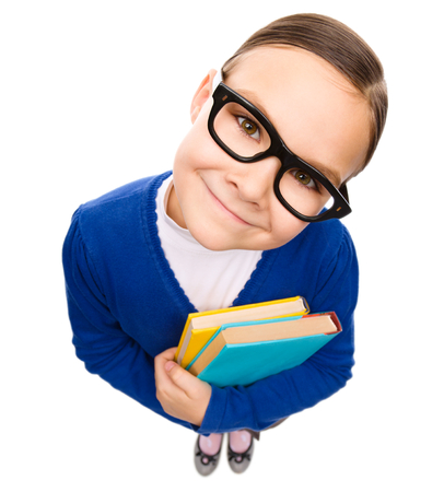 Funny little girl is holding books, fisheye portrait, isolated over whiteの写真素材