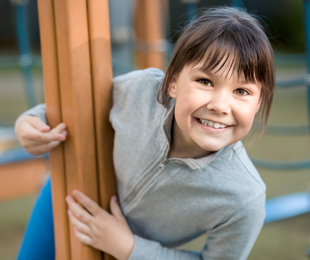 Cute little girl is playing in playground, outdoor shootの写真素材