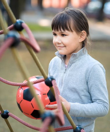 Cute little girl is playing in playground, outdoor shootの写真素材