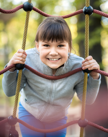 Cute little girl is playing in playground, outdoor shootの写真素材