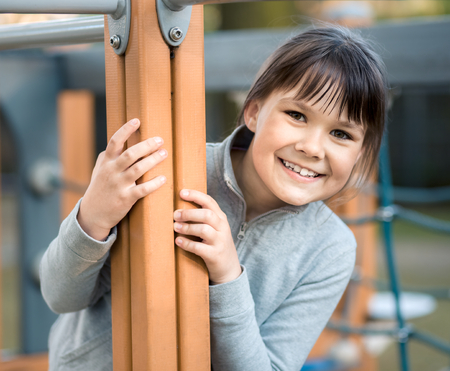 Cute little girl is playing in playground, outdoor shootの写真素材