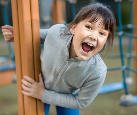Cute little girl is playing in playground, outdoor shootの写真素材