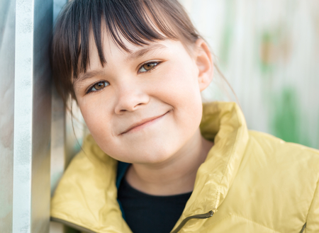 Portrait of a girl leaning to the wall, outdoor shootの写真素材