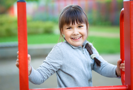 Cute little girl is playing in playground, outdoor shootの写真素材
