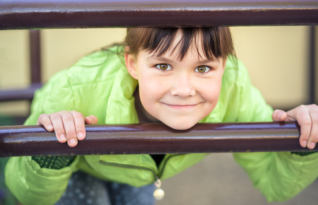 Cute little girl is playing in playground, outdoor shootの写真素材