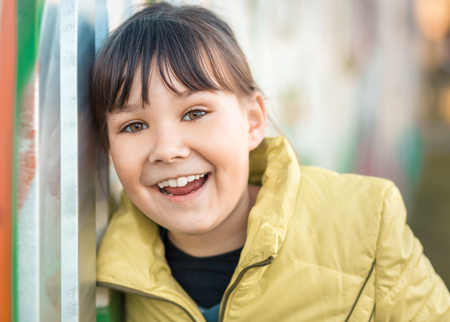 Portrait of a girl leaning to the wall, outdoor shootの写真素材
