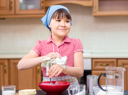 Girl is cooking in kitchen, indoor shootの写真素材