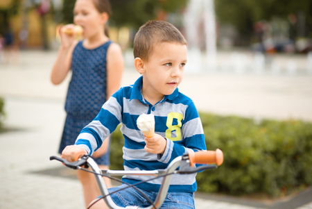 Two children, sister and brother, are playing outdoorsの写真素材