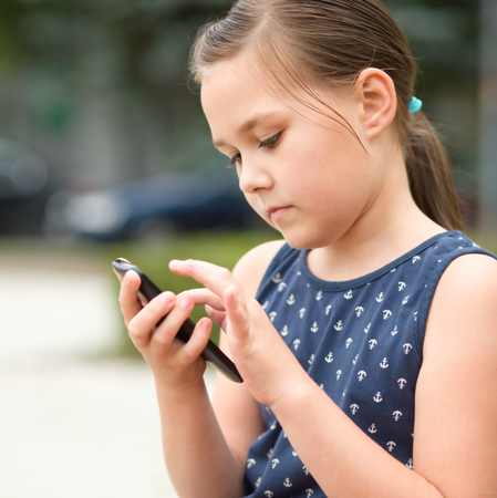 Girl is using smartphone, outdoor shootの写真素材