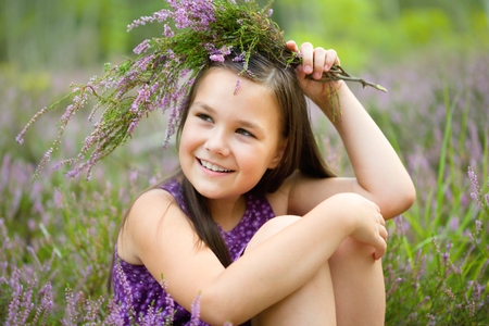 Girl is holding bunch of heather flowers, outdoor shootの写真素材