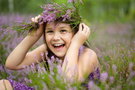 Girl is holding wreath of heather flowers, outdoor shootの写真素材