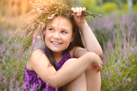 Girl is holding bunch of heather flowers, outdoor shootの写真素材