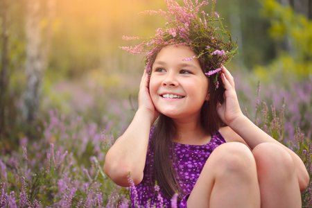 Girl is holding wreath of heather flowers, outdoor shootの写真素材