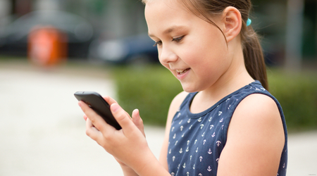Girl is using smartphone, outdoor shootの写真素材