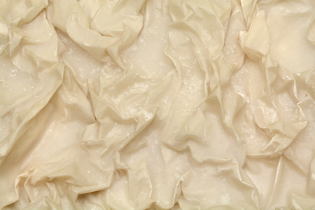 frozen brown paper, crumpled paper background with ice