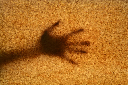Shadow hands on the background of old paperの写真素材