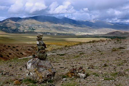 Folded stones in a row against the backdrop of the mountains in the Altai Territoryの写真素材
