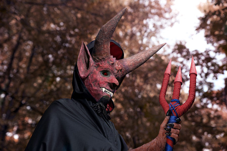 Devil in the dark forest. Autumn holiday Halloween