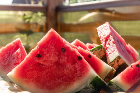 Fresh sliced â€‹â€‹red and juicy watermelon on the table. In the bright summer sun. Sweet...