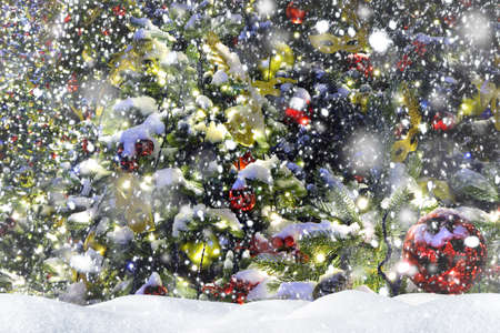 Background of a Christmas tree decorated with Christmas decorations. Snowy New Year's Eve. Festive...