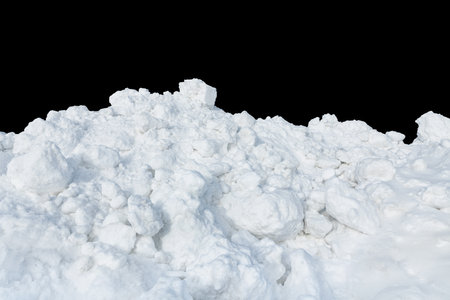 Lumps of snow on a black isolated background. Snowy landscape. Snow removal after a snowfall. Snowballs.の写真素材