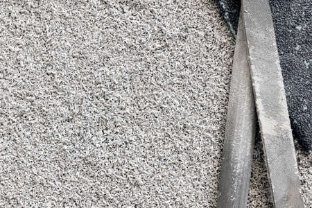 Files for processing plastic, wood, metal. The background is made of vinyl or plastic sawdust. The...