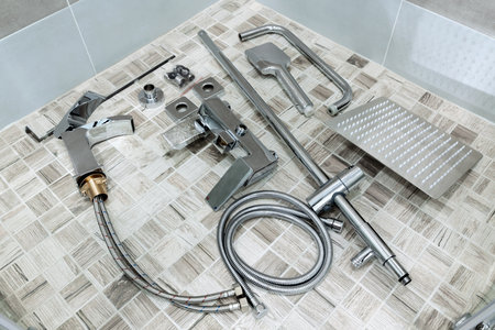 Plumbing accessories in the bathroom. Water faucet, hoses, shower head, water faucet. Items for wall mounting and connection.の写真素材
