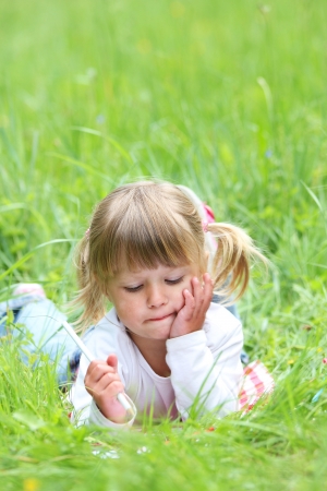 a beautiful little girl on the nature ofの写真素材