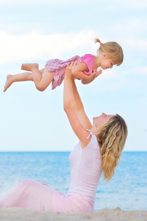 Mother and daughter on the banks of the seaの写真素材