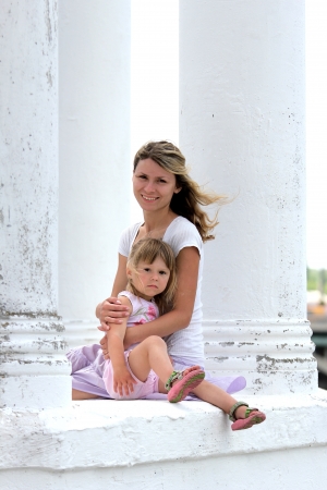 a young mother with her daughter on the natureの写真素材