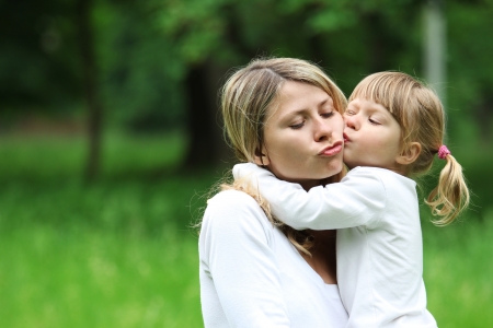 a young mother with her daughter on the natureの写真素材